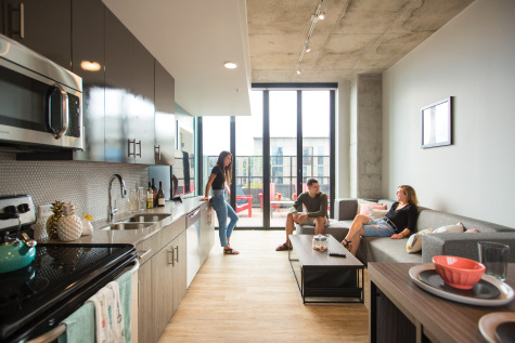 People in apartment with view from kitchen
